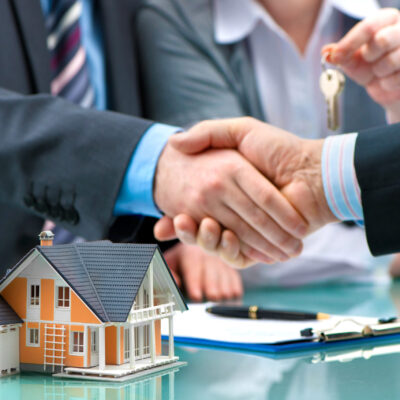 Estate agent shaking hands with customer after contract signature